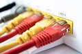 A home router for access to the Internet and a cable of different colors. in each port cable, Royalty Free Stock Photo