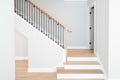 A home`s wooden staircase with wrought iron spindles. Royalty Free Stock Photo