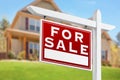 Home For Sale Real Estate Sign in Front of Beautiful New House Royalty Free Stock Photo