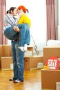 Home for sale sign and guy holding girlfriend Royalty Free Stock Photo