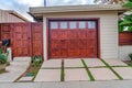 Home in San Diego California with glass paned garage door beside wooden gate