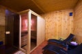 Sauna interior with two sunbeds and cherry wood walls Royalty Free Stock Photo