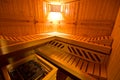 Sauna interior cabin detail with open door and lit lighting Royalty Free Stock Photo