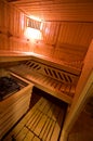 Sauna interior cabin detail with open door and lit lighting Royalty Free Stock Photo