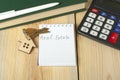 Home savings, budget, financial and property concept. Model house, keys, calculator and notepad with text REAL ESTATE on Royalty Free Stock Photo