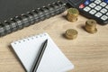Home savings, financial and budget concept. Calculator, pen and coins on office table Royalty Free Stock Photo