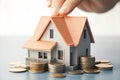 Home savings plan House model, coins, hand for real estate Royalty Free Stock Photo