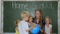 Home school concept. A mother gives her children a geography lesson with a globe in her hands. Royalty Free Stock Photo