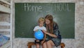 Home school concept. A mother gives her children a geography lesson with a globe in her hands. Royalty Free Stock Photo