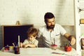 Home school. Team work drawing, father and son paint together, father teaches his son how to paint correct and beautiful Royalty Free Stock Photo