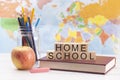 Home Schooling Background with School Supplies and a World Map in the Background