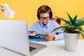 Home schooling and distance education for children. schoolboy sitting at a table reading a book, learning by video link with a Royalty Free Stock Photo