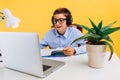 Home schooling and distance education for children. schoolboy sitting at a table reading a book, learning by video link with a Royalty Free Stock Photo