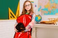 Home schooling. Funny little pupil wearing glasses. Pupil of primary school with puppy. Girl with gog in backpack near Royalty Free Stock Photo