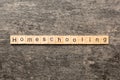 Home schooling word written on wood block. Homeschooling text on table, concept Royalty Free Stock Photo