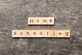 Home schooling word written on wood block. Home schooling text on table, concept Royalty Free Stock Photo