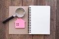 Home search, house trading ideas.Model house on a notebook and a magnifying glass.Search for real estate concept houses on the Royalty Free Stock Photo