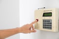 Home security system with hand pushing red button Royalty Free Stock Photo