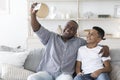 Home Selfie. Smiling black grandfather with preteen grandson taking photo together Royalty Free Stock Photo