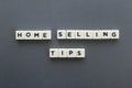 Home selling tips word made of square letter word on grey background.