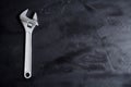 Home servises. Customer service and client support. Wrench on the blackboard. Copy space, background. Royalty Free Stock Photo