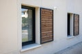 home shutter wood windows with modern wooden brown sliding shutters in house beige new facade apartment city building Royalty Free Stock Photo