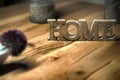 Home sign balanced on wooden table contrast- rest and relaxation