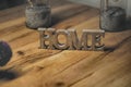 Home sign balanced on wooden table- rest and relaxation
