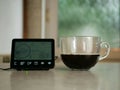 Home smart meter with cup of coffee on kitchen counter Royalty Free Stock Photo