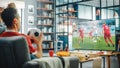 At Home Soccer Fans Sitting on a Couch Watch Football Game on TV, Cheer for Favourtite Sports Team Royalty Free Stock Photo