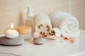 Home spa self care products in bathroom, facial massage rolling tool, moisturizing creams and oil, creamy bath bomb. Royalty Free Stock Photo