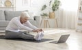 Active Senior Woman Doing Warming Stretching Exercises In Front Of Laptop Royalty Free Stock Photo