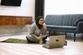 Arab woman doing gymnastics in the bedroom. She's at home. Royalty Free Stock Photo