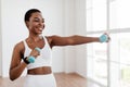 Afro Sporty Woman Exercising With Two Dumbbells And Posing Royalty Free Stock Photo