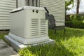 A Home Standby Generator installed at the backyard of a house. An air-cooled natural gas or liquid propane generator for Royalty Free Stock Photo