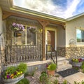 Home with stone wall and stairs leading to a porch