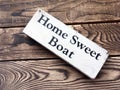 Home Sweet Boat sign on dark wooden boards Royalty Free Stock Photo