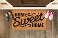 Home Sweet Home doormat with man and woman shoes on the porch at the front door Royalty Free Stock Photo