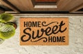 Home Sweet Home doormat on the porch at the front door Royalty Free Stock Photo