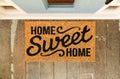 Home Sweet Home doormat on the porch at the front door Royalty Free Stock Photo