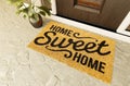 Home Sweet Home doormat on the porch at the front door Royalty Free Stock Photo