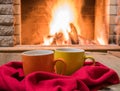 Home sweet home concept. Two mugs of tea near cozy fireplace, Royalty Free Stock Photo