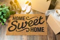 Home Sweet Home Welcome Mat, Moving Boxes, Women and Male Shoes Royalty Free Stock Photo