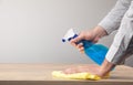 Home table cleaning, table surface disinfection with a disinfectant spray Royalty Free Stock Photo