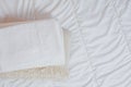 home textiles Flatlay. A stack of towels lies on a white bed