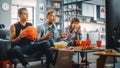 At Home Three Joyful Basketball Fans Sitting on a Couch Watch Game on TV, Tense Moment Befofre Last