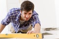 Home tile improvement - handyman with level Royalty Free Stock Photo