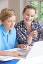 Female Home Tutor Helping Boy With Studies Using Laptop Computer Royalty Free Stock Photo