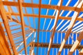 Home under construction with timber trusses framed construction roofing a joints Royalty Free Stock Photo