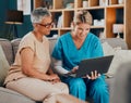 Home visit, woman and doctor with laptop on sofa checking medical results or chart online. Healthcare, technology and Royalty Free Stock Photo